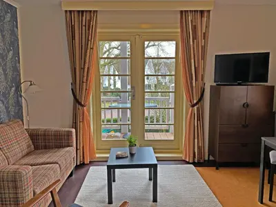a living room with a couch and two windows at Villa Prinsenhof # Zeventien in Bergen