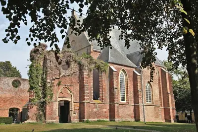 an old brick church with a large building at Villa Prinsenhof # Zeventien in Bergen