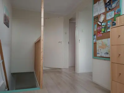 a room with white walls and a hallway with a closet at Het Dijkstuk in Noordwijkerhout