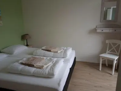 a bedroom with a bed with towels on it at Het Dijkstuk in Noordwijkerhout