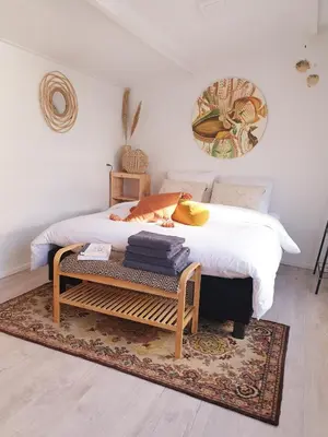 a bedroom with a bed and a table with towels at Little Lodge Noordwijk aan Zee in Noordwijk