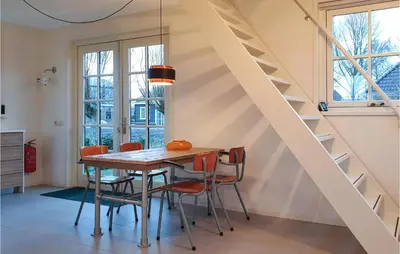 a dining room with a wooden table and chairs at Lovely Home In Wijdenes With Wifi in Wijdenes