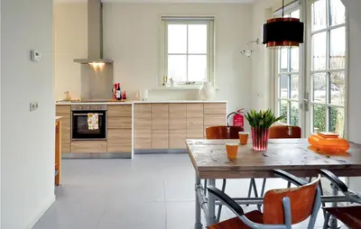 a kitchen and dining room with a table and chairs at Lovely Home In Wijdenes With Wifi in Wijdenes