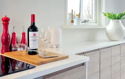 a bottle of wine and wine glasses on a counter at Lovely Home In Wijdenes With Wifi in Wijdenes