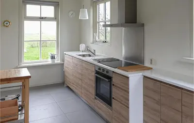 a kitchen with a sink and a stove at Lovely Home In Wijdenes With Wifi in Wijdenes