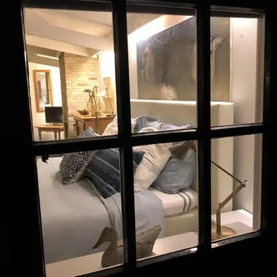 a view of a bedroom through a window at Schoorl Seasons Garden House 2026 in Schoorl