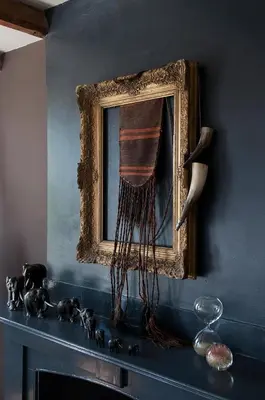 a picture on a blue wall with a mirror and a fireplace at RiverSide Suite - Haarlem City Centre in Haarlem