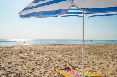 a blue and white umbrella on the beach at Zee & Zo in Zandvoort