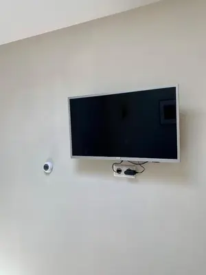 a flat screen tv hanging on a white wall at Beach Studio 35 with private parking in Zandvoort