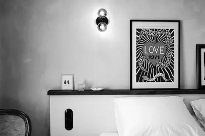 a bedroom with a bed with a picture on the wall at Boutique Hotel & Restaurant Frenchie in Haarlem