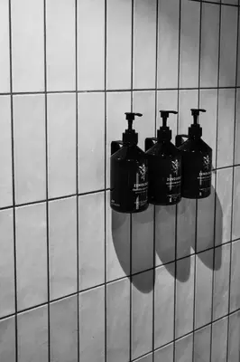 four fire hydrants are hanging on a wall at Boutique Hotel & Restaurant Frenchie in Haarlem