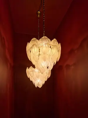 a large white chandelier hanging from a ceiling at Boutique Hotel & Restaurant Frenchie in Haarlem
