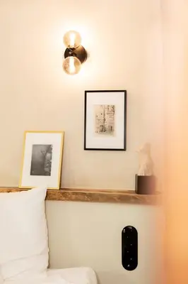 a bedroom with two pictures on the wall and a bed at Boutique Hotel & Restaurant Frenchie in Haarlem