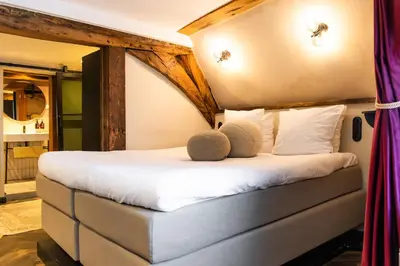 a bedroom with a bed with two pillows on it at Boutique Hotel & Restaurant Frenchie in Haarlem