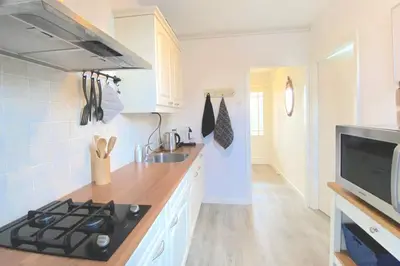 a kitchen with a stove and a sink at Who's Anton? Monnickendam, vlak bij Amsterdam in Monnickendam
