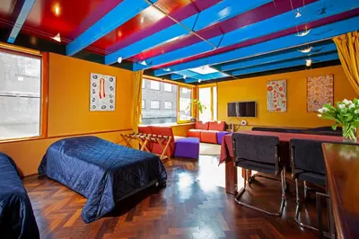 a room with a bed and a table and chairs at Dreamtime Houseboat in Amsterdam