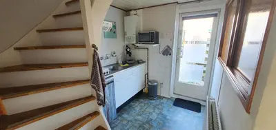 a small kitchen with a sink and a stove at 'Heerlijk Zomerhuis Vlakbij Strand en Duinen' in Egmond aan Zee
