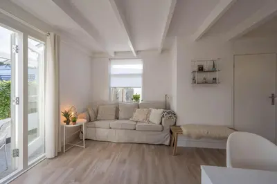 a white living room with a couch and a table at Villa Bo Junior in Bergen