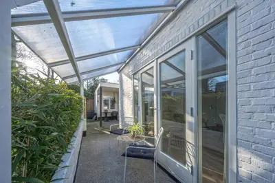 a glass extension to a house with plants at Villa Bo Junior in Bergen