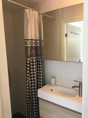 a bathroom with a sink and a mirror at Villa Bo Junior in Bergen