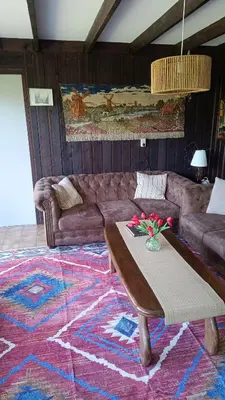 a living room with a couch and a table at Vakantiehuis Friedeburg in Warmenhuizen