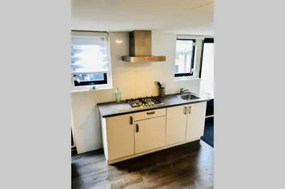a kitchen with a sink and a stove top oven at Have a nice stay! - Blue Beach House 350 meters from sea in Noordwijk aan Zee