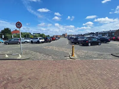 a parking lot with a lot of cars parked at Have a nice stay! - Blue Beach House 350 meters from sea in Noordwijk aan Zee