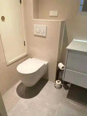 a bathroom with a white toilet and a sink at Prinsengracht Museum Bed and Breakfast in Amsterdam