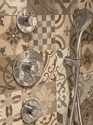 a bathroom with three faucets on a tile floor at Prinsengracht Museum Bed and Breakfast in Amsterdam