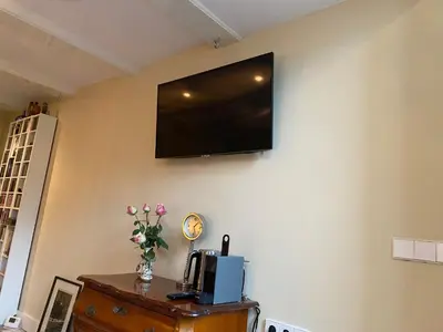 a flat screen tv on the wall of a room at Prinsengracht Museum Bed and Breakfast in Amsterdam