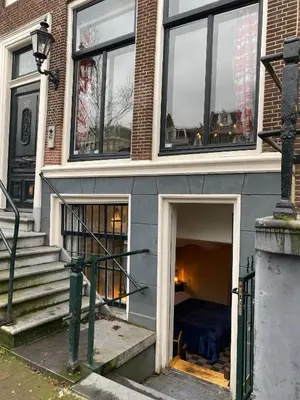 a bedroom in a house with a bed in it at Prinsengracht Museum Bed and Breakfast in Amsterdam