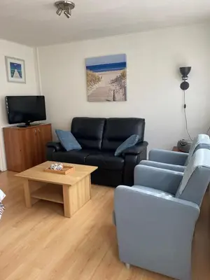 a living room with a couch and a coffee table at Torensdoin in Egmond aan Zee