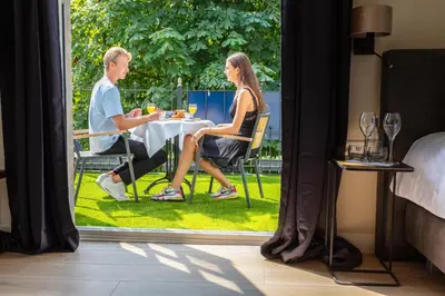 a man and a woman sitting at a table at Grandcafé Boutique Hotel Eemland in Eemnes