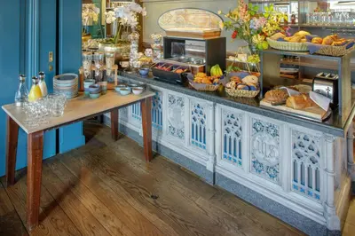 a buffet with bread and other food on a table at Grandcafé Boutique Hotel Eemland in Eemnes