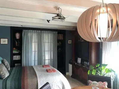 a bedroom with a bed and a television in it at B&B De Kamer in Wervershoof