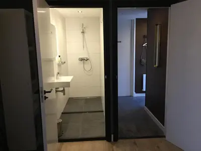 a bathroom with a sink and a shower at B&B De Kamer in Wervershoof