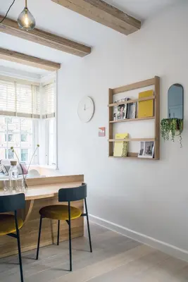 a dining room with a wooden table and chairs at Studios at the canal in Amsterdam