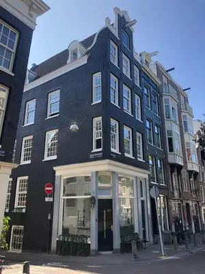 a large black building on the corner of a street at Studios at the canal in Amsterdam