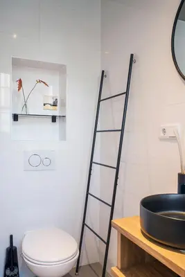 a bathroom with a black sink and a toilet at Studios at the canal in Amsterdam