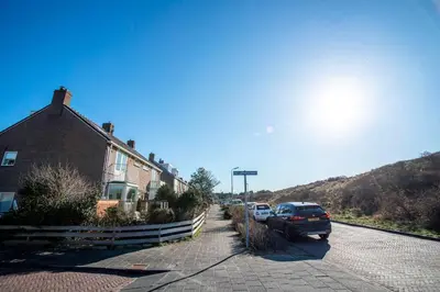 a street with cars parked next to a house at Studio Jadana in Zandvoort