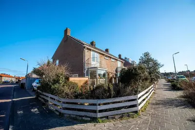 a house with a fence in front of it at Studio Jadana in Zandvoort