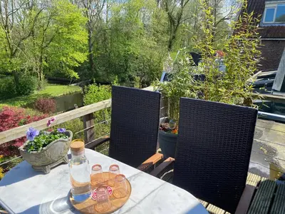 a table with a bottle on it on a patio at Park View Apartment in Amsterdam