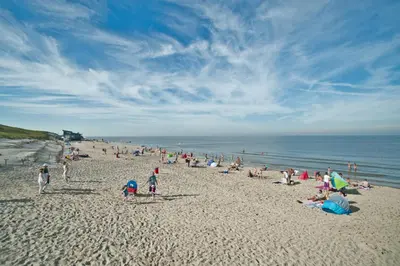 a large group of people on a beach at Hotelhuisje Warmenhuizen #B in Warmenhuizen