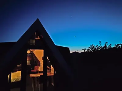 a view of a house from the outside at night at Hotelhuisje Warmenhuizen #F in Warmenhuizen