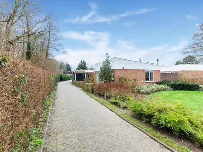 a cobblestone road in front of a brick building at Holiday Home in Noordwijkerhout near Lake in Noordwijkerhout