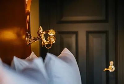 a close up of a bedroom door with a gold latch at Boutique Hotel The Noblemen in Amsterdam