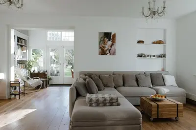 a living room with a couch and a table at Dune and Beach Villa with very large and beautiful Garden in Schoorl