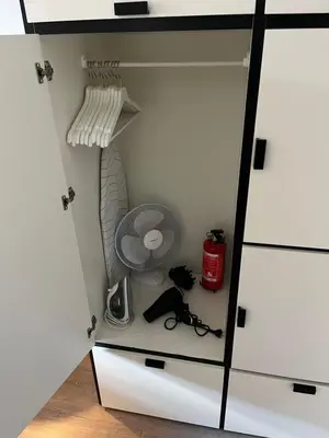 a cupboard with a door open with a shelf at Modern Hideout Ace Location in Amsterdam