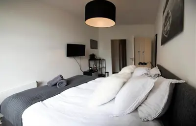 a bedroom with a bed with white pillows on it at Modern Hideout Ace Location in Amsterdam