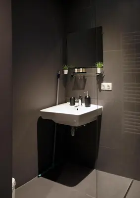 a bathroom with a white sink and a shower at Modern Hideout Ace Location in Amsterdam